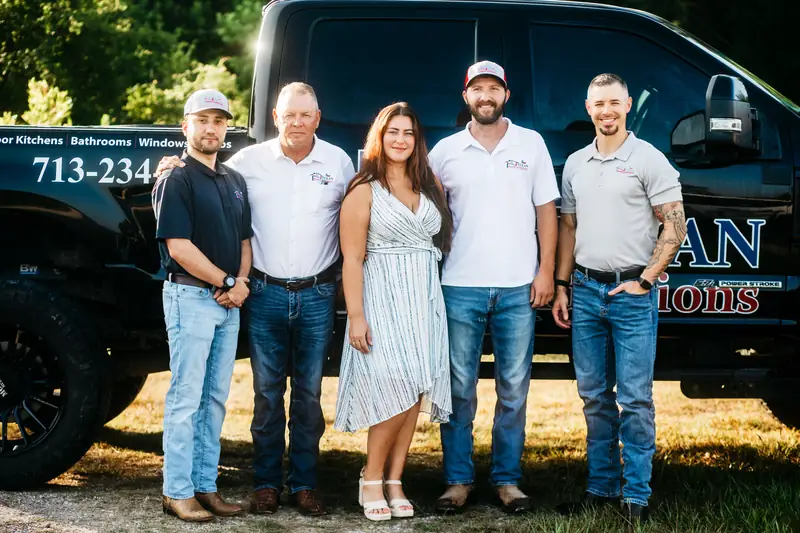 The Texan Home Additions team standing together in front of a company truck.