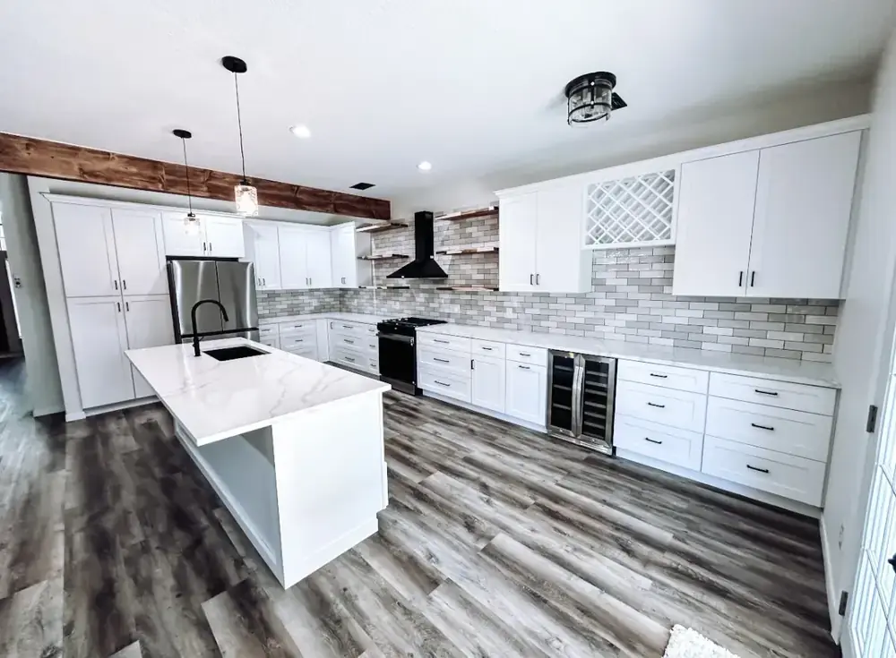 Matte-black range hood and gas range centered between floating wood shelves on a glossy subway-tile wall